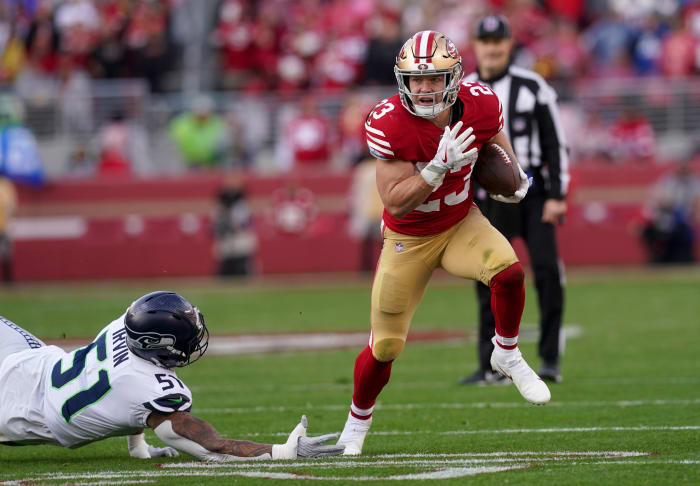 Jan 14, 2023; Santa Clara, California, USA; San Francisco 49ers running back Christian McCaffrey (23) gets past Seattle Seahawks linebacker Bruce Irvin (51) in the second quarter during a wild card game at Levi's Stadium. Mandatory Credit: Cary Edmondson-USA TODAY Sports